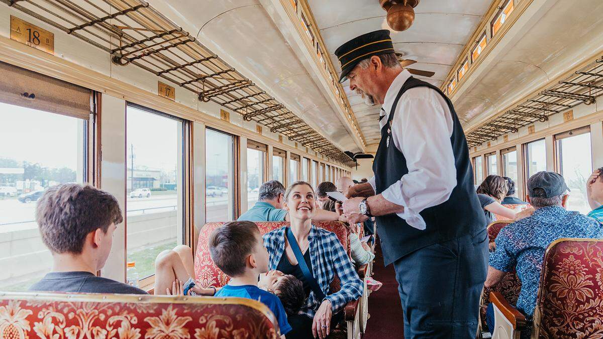 Passengers aboard the Grapevine Vintage Railroad enjoy a trip back in time, complete with an old timey conductor.