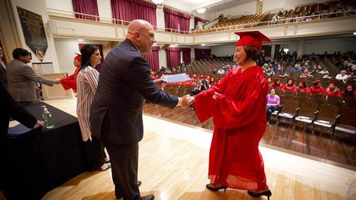 Fort Worth Superintendent Kent Scribner congratulates Parent University participant Monica Rodriguez during the program’s 2018 graduation ceremony. The Fort Worth school district plans to take the parent outreach program district-wide in the fall.