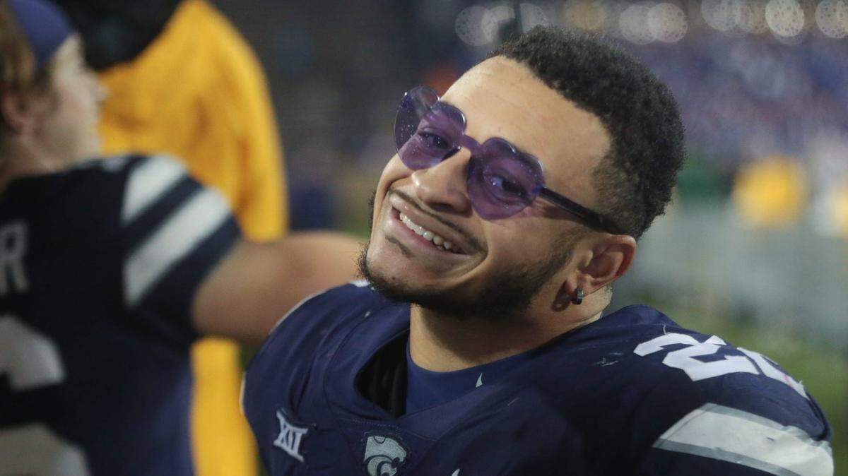 Kansas State junior running back Deuce Vaughn (21) poses with heart-shaped glasses given by a fan after beating Kansas 47-27 during the Sunflower Showdown at Bill Snyder Family Stadium on Nov. 26. Kansas State would go on to claim the Big 12 Championship and play Alabama in the Sugar Bowl on Dec. 31.