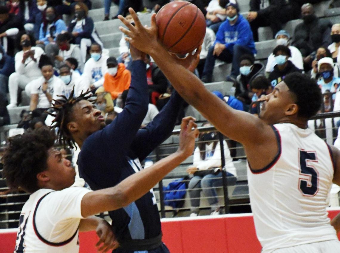 O.D. Wyatt’s Kendall Fair, center goes up for the basket and draws the foul for a three point play as Ryan’s Marcette Lawson, left and Ja’Tavion Sanders defend during the second period of their 5A Region I Area playoff game Thursday, February 25, 2021 at Colleyville Heritage High School in Colleyville, Texas. Wyatt went on to win 59-44. Special/Bob Haynes