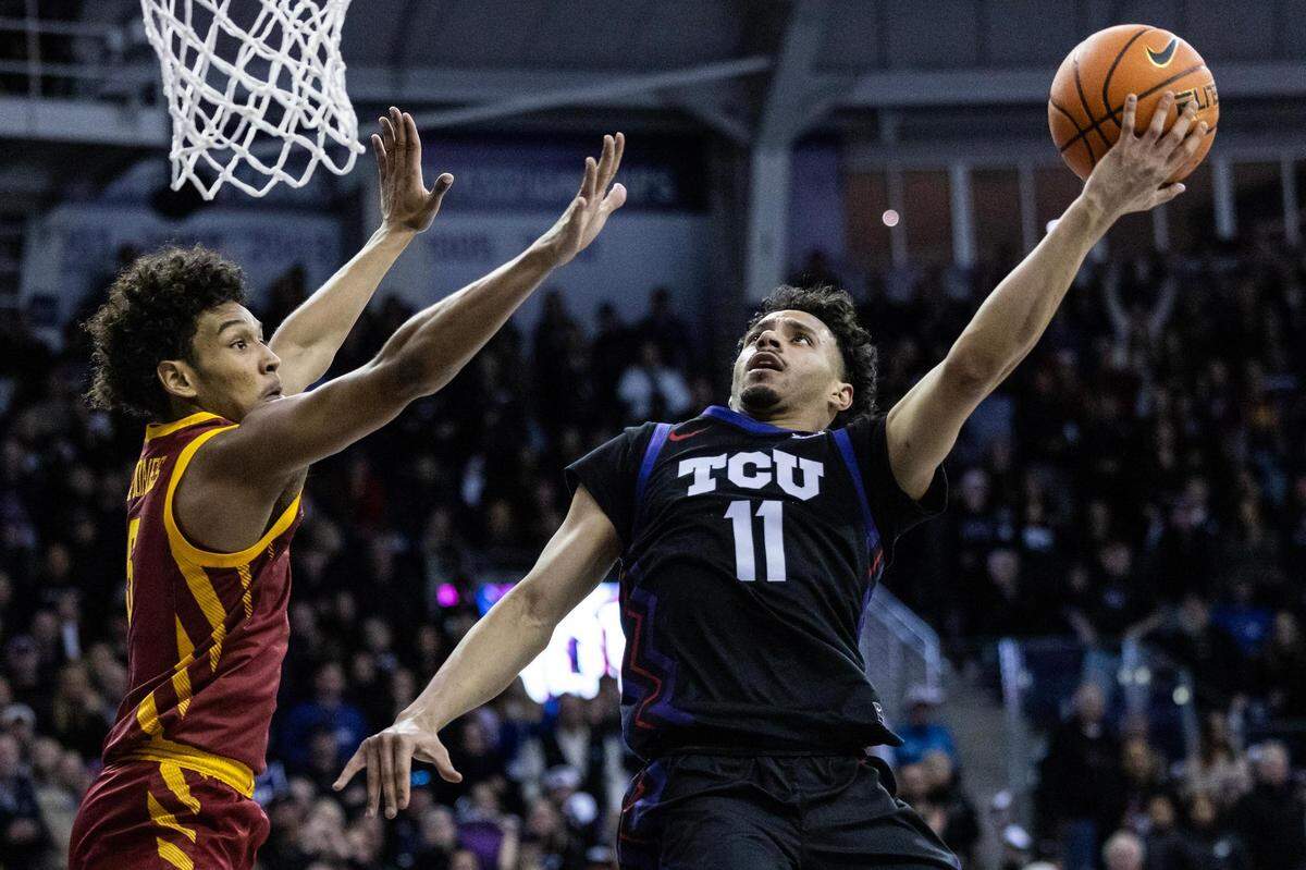 TCU guard Trevian Thompson (11) goes up for a contested layup against Iowa State guard Curtis Jones (5) to cut the Iowa State lead to the four in the last minute of the second half of a Big XII conference game between the TCU Horned Frogs and Iowa State Cyclones at Schollmaier Arena in Fort Worth on Saturday, Jan 20, 2024. TCU lost the game 73-72.