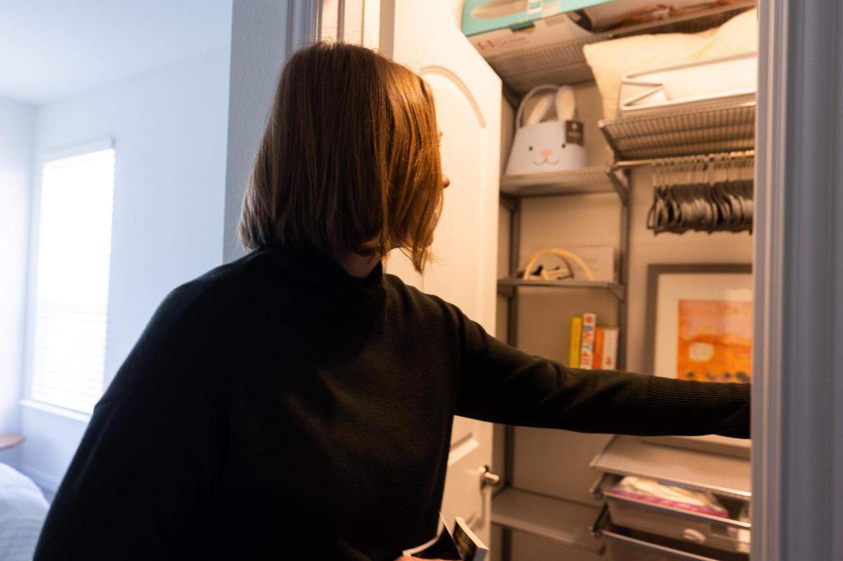 Kara Gardeen turns off the light in a closet she started to set up for a second child Feb. 18, 2022, in Keller.