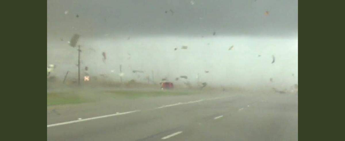 An image captured from video shot by storm chaser Brian Emfinger on March 21, 2022, near Texas 95 in Elgin shows Riley Leon’s Chevrolet Silverado truck being flipped on its side and spun around before flipping it back upright.