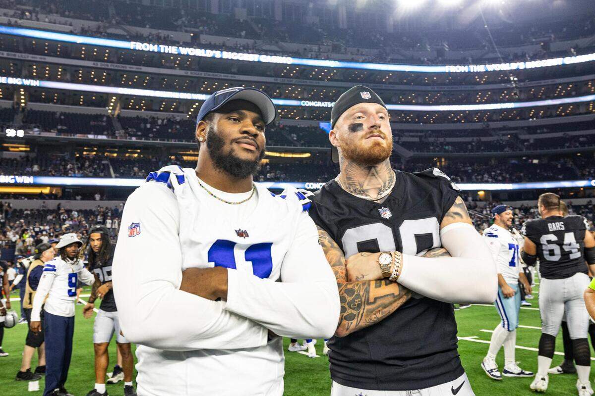 Dallas Cowboys defensive end Micah Parsons takes a photo with Las Vegas Raiders defensive end Maxx Crosby after a preseason game at AT&T Stadium in Arlington, Texas on Saturday, Aug. 26, 2023.