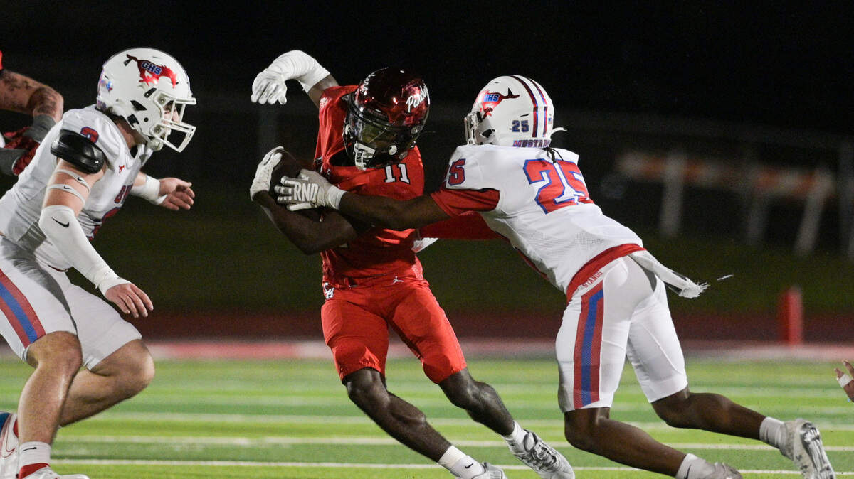 Colleyville Panther running back Jerrod Wiley (11) attempts to avoid a tackle from Grapevine Mustang defensive back Lanel Randolph (25) during a UIL football game against Grapevine High School at Mustang Panther Stadium in Grapevine, Texas on Friday, Nov. 8, 2024.