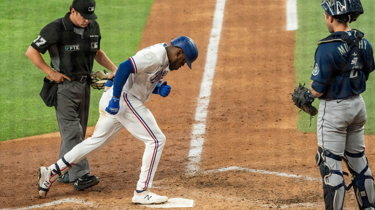 Texas Rangers’ Adolis Garcia crosses the plate after hitting a solo home run in the sixth inning in Thursday’s 9-8 loss to the Seattle Mariners. It was Garcia’s 27th home run, the second-most for a Rangers rookie behind Pete Incaviglia’s 30 in 1986.