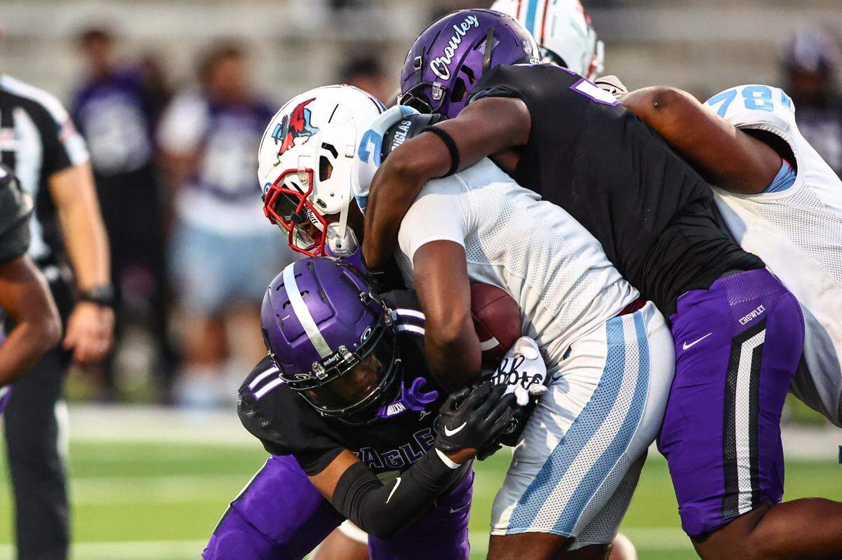 A pair of Crowley defenders tackle Skyline running back Tramell Minter at Crowley ISD Stadium on September 12, 2024.