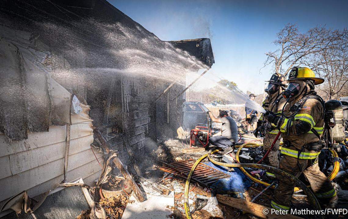Fort Worth firefighters battle a blaze at a residence in the 4600 block of Shackleford Street in east Fort Worth on Dec. 31, 2025.