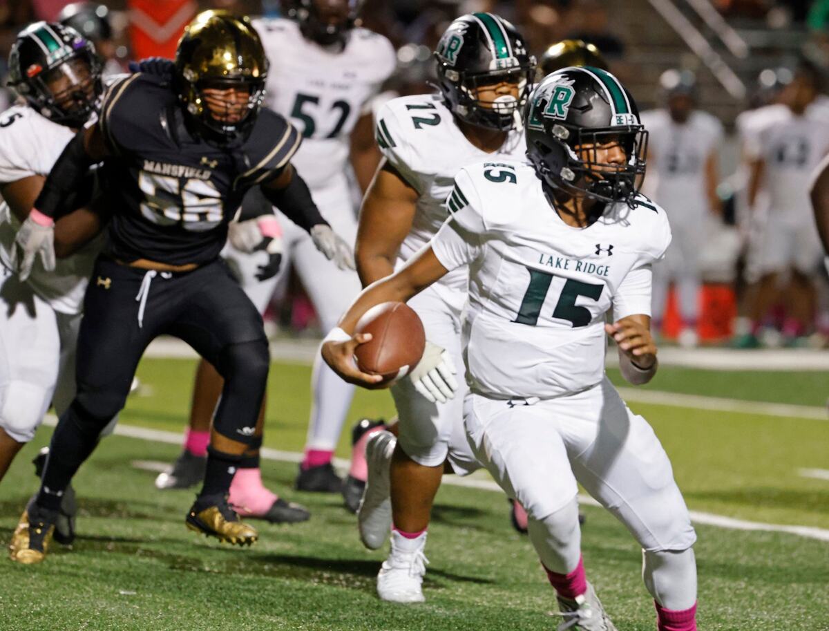Lake Ridge quarterback Deshawn Edwards (15) looks for room around the right side during a UIL football game at Vernon Newsom Stadium in Mansfield Texas, Thursday, Oct. 03, 2024.