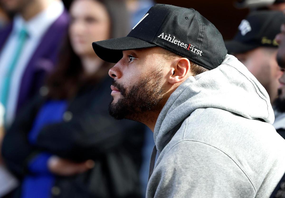 Dallas Cowboys quarterback Dak Prescott listens to new coach Brian Schottenheimer speak during a press conference on Monday, Jan. 27, 2025, at The Star in Frisco.