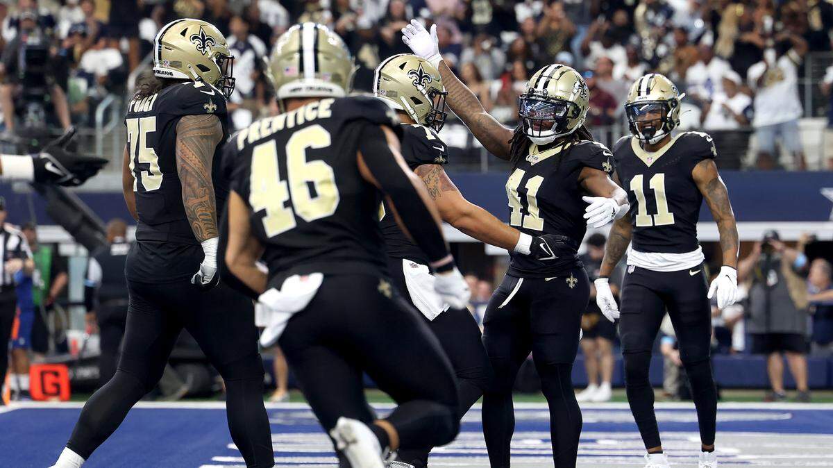 The New Orleans Saints celebrate a touchdown by running back Alvin Kamara on Sunday, Sept. 15, 2024, at AT&T Stadium in Arlington.