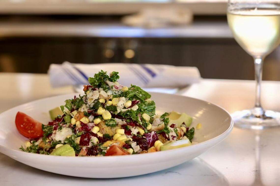 A chopped salad with chicken, kale, radicchio, blue cheese, avocado and corn at Cork & Pig Tavern.