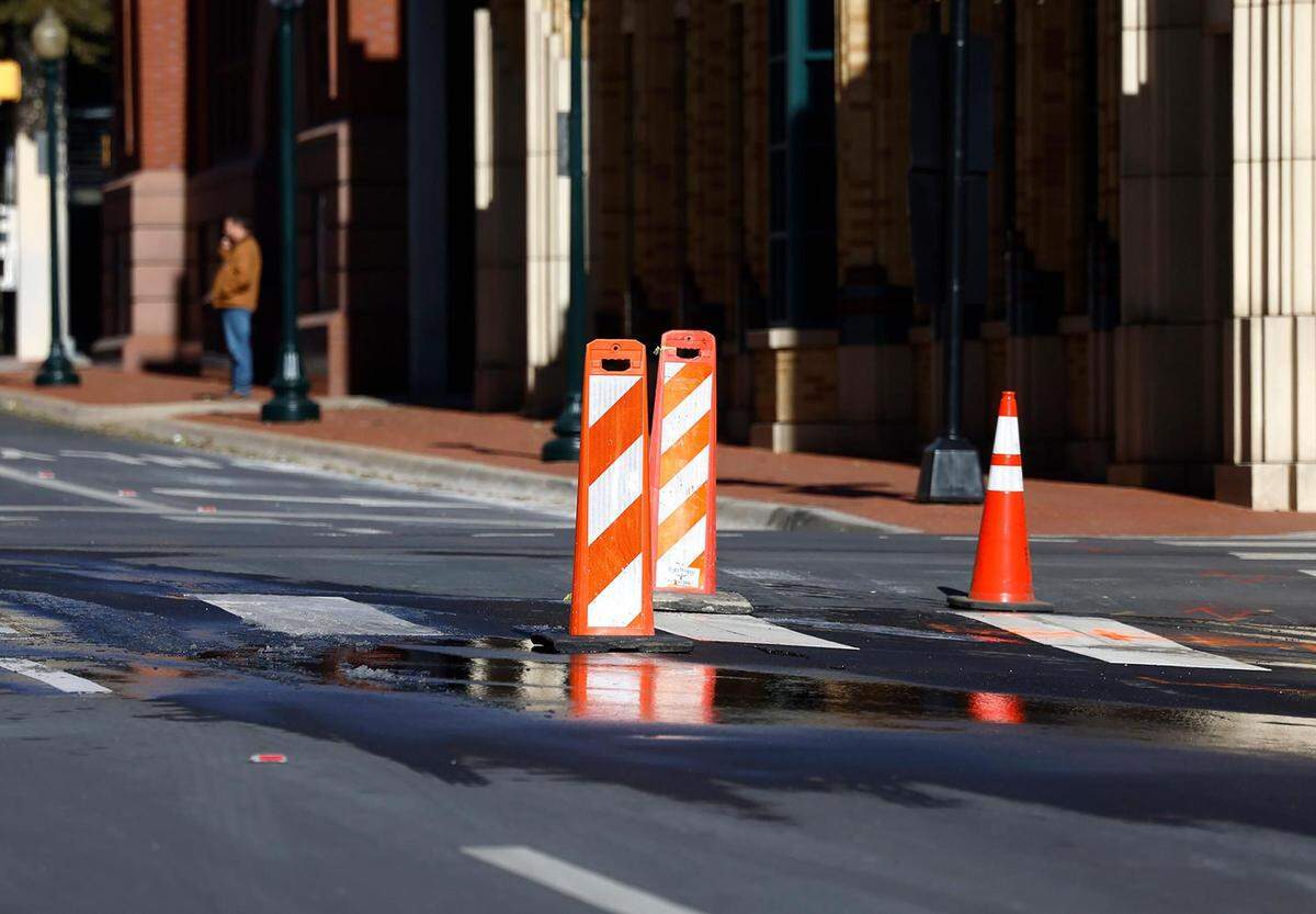 Traffic cones block off part of Calhoun Street near the intersection of East Fifth Street where a water line broke on Tuesday, January 16, 2023.