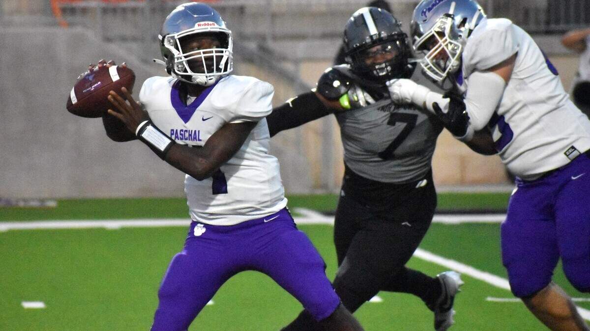 Fort Worth Paschal’s Jashuan Thomas passes the ball while North Crowley’s Dacorien Thompson pursues him during a 2023 game at Crowley ISD Stadium.