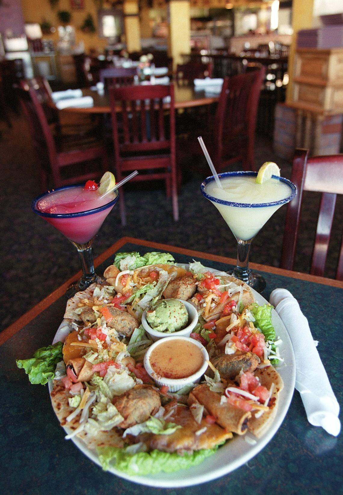 The fiesta platter at Cristina's Mexican Restaurant includes flautitas, stuffed jalapenos, quesadillas, chile con queso and guacamole. Pictured with a sangaria swirl margarita and a lime margarita.