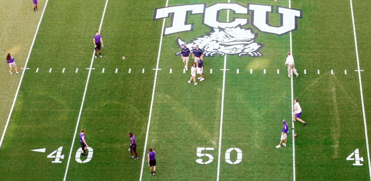 TCU players toss the ball around during pregame over the “Pony Up” that was marked into the field by SMU fans before the TCU vs SMU College Football game at Amon Carter Stadium in Fort Worth on September 22, 2007.