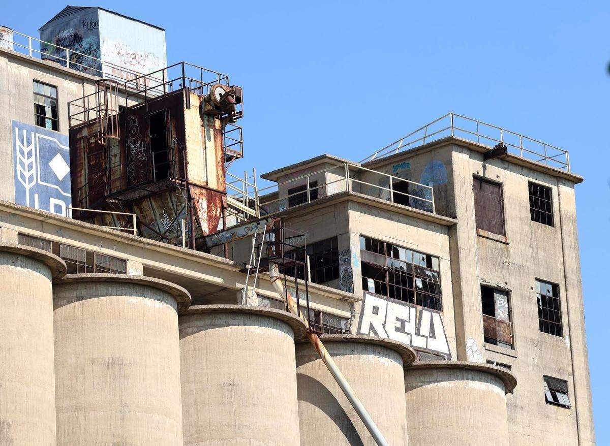 Graffiti on grain silos rise above the Worth Heights neighborhood of Fort Worth on Thursday.