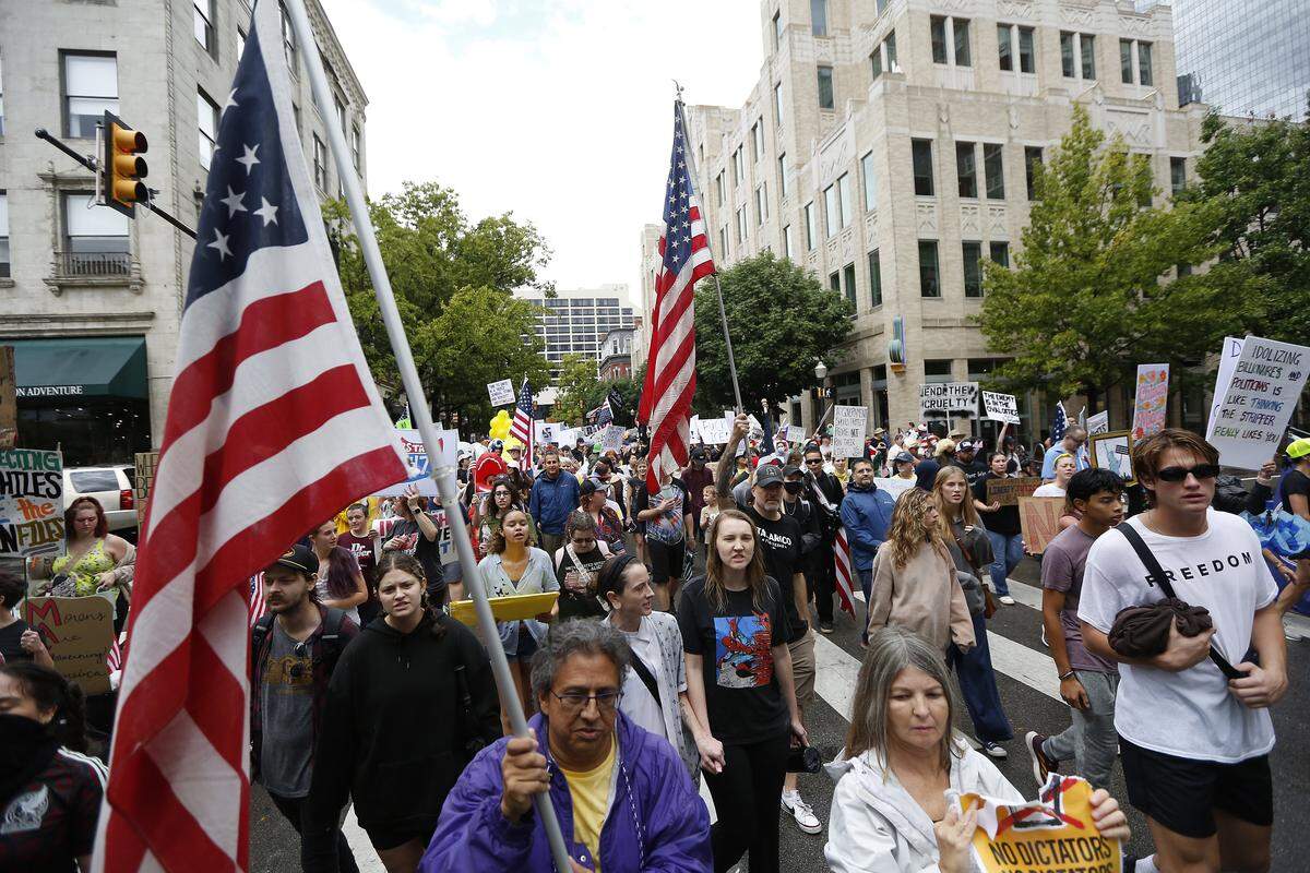 A large crowd marches through downtown streets during the No Kings Rally in Fort Worth on Saturday, Oct. 18, 2025.