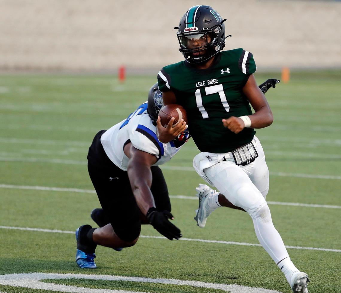 Lake Ridge quarterback Kennen Miller outruns Summit linebacker Jaden Williams (9) in the first half of their season opener Friday.