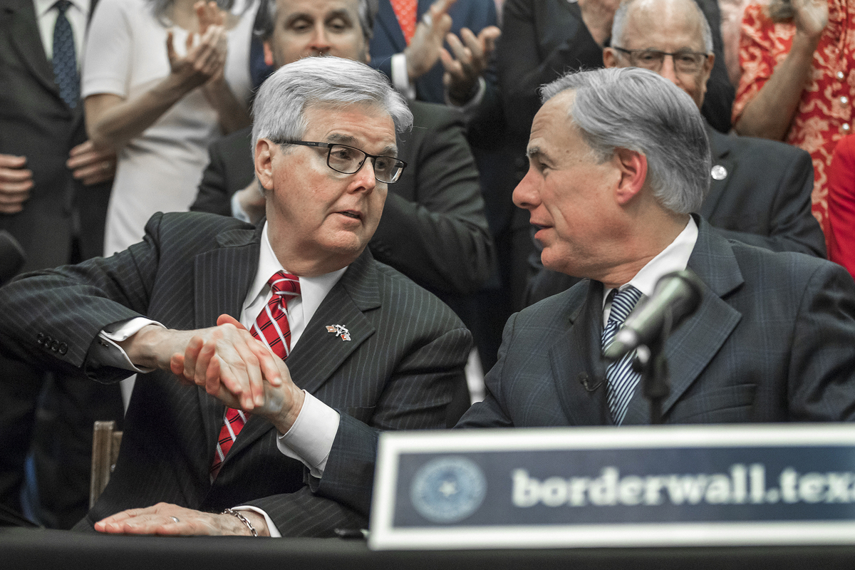 Lieutenant Gov. Dan Patrick, left, shakes hands with Gov. Greg Abbott during a press conference on details of his plan for Texas to build a border wall and provide $250 million in state funds as a “down payment.”, Wednesday, June 16, 2021 in Austin, Texas. (Ricardo B. Brazziell/Austin American-Statesman)