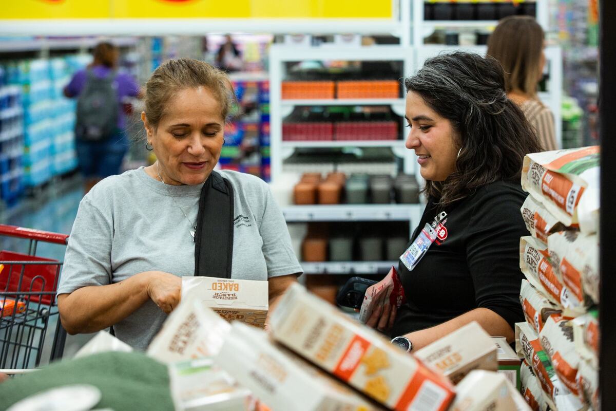 Ezzie Garcia, left speaks with HEB worker Evelyn, right, during the grand opening of HEB on Wednesday, June 26 in Mansfield. Garcia is from San Antonio and is very exited for the grand opening and has been waiting in line since 4am.