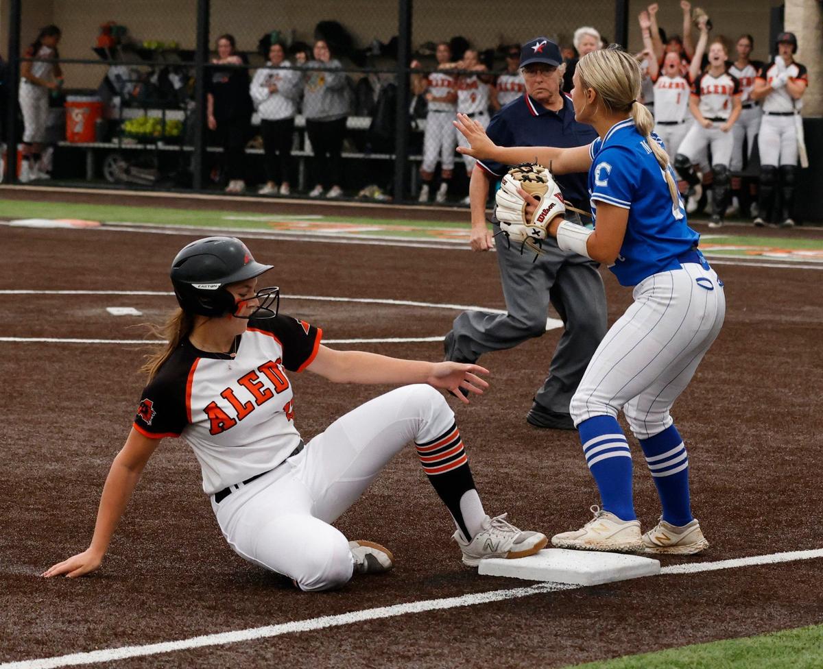 Centennial third baseman Hannah McCurry signals to hold the ball as Aledo third baseman Kyleigh Pawlak reaches third during the UIL Conference 5A Region 1 final softball game at Aledo, Texas, Wednesday, May 22, 2024.