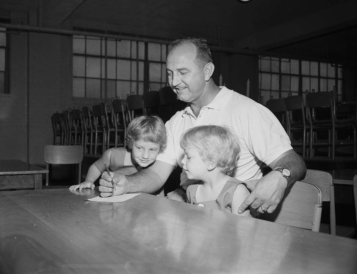Aug. 23, 1958: Joe Burns, accompanied by daughters Toy, left, and Honey, 3, was one of the early Saturday voters at the Precinct 94 box in the second Democratic primary.