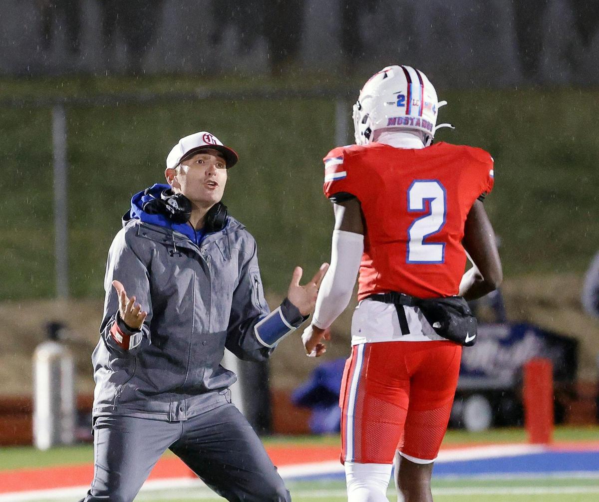 Grapevine assistant coach Jordon Sweatt gets emotional with wide receiver Derrius Burns (2) in the first half of a UIL 5A D2 football playoff game at Mustang Panther Stadium in Grapevine, Texas, Thursday, Nov. 09, 2023.