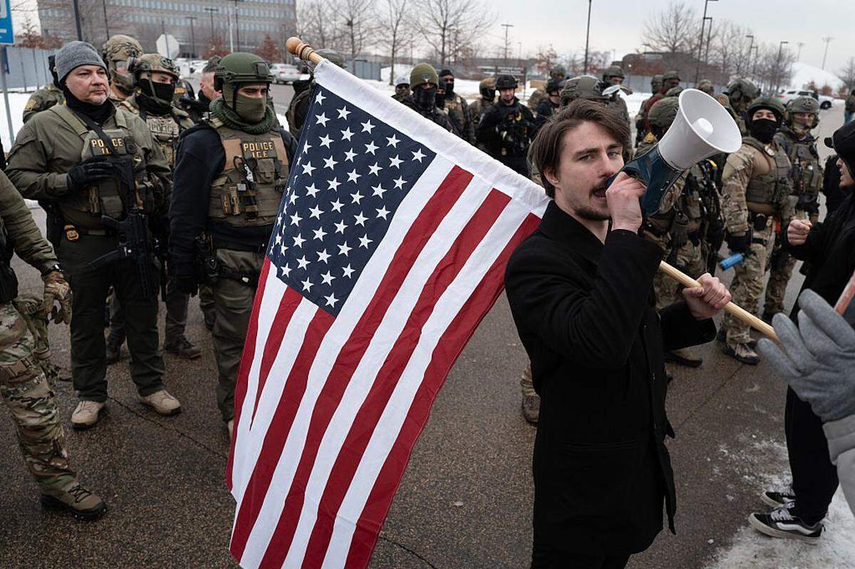 A supporter of ICE operations confronts anti-ICE demonstrators during a protest on Jan. 8 in Minneapolis.
