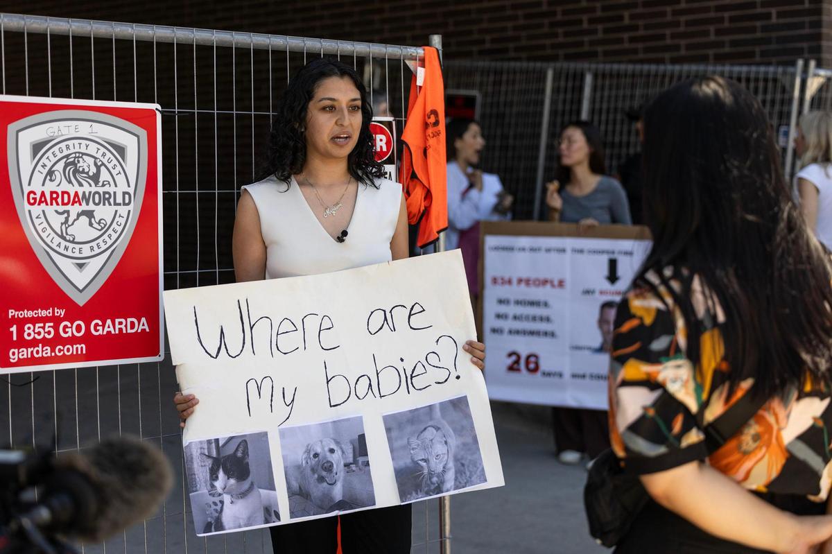 Miriam Zarza, a two-month resident at The Cooper, holds her sign while being interviewed by the media during a protest outside the apartments in Fort Worth on July 23. Residents planned a protest to mark one month since a fire displaced more than 800 residents and left them without their belongings. Zarza is one of dozens of tenants who are suing the apartments’ owner, management and an electrical contractor.