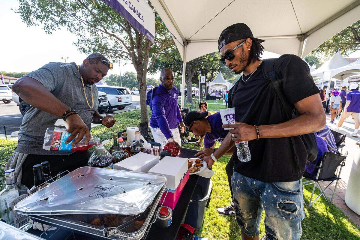 Tominque White, left, and Kvo Kreation serves themselves food and drinks at their Channing Canada tent prior to the TCU football game against the Colorado Buffaloes at Amon G. Carter Stadium in Fort Worth on Saturday, Sept. 2, 2023.