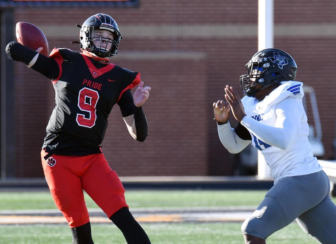 Colleyville Heritage quartrback AJ Smith- Shawver, left, throws down the field under pressure from Mansfield Summit’s Joseph Adedire in the second quarter of their Division 1-5A Regional Round Play-off football game Saturday, December 26, 2020 at Bearcat Stadium in Aledo, Texas. Special/Bob Haynes