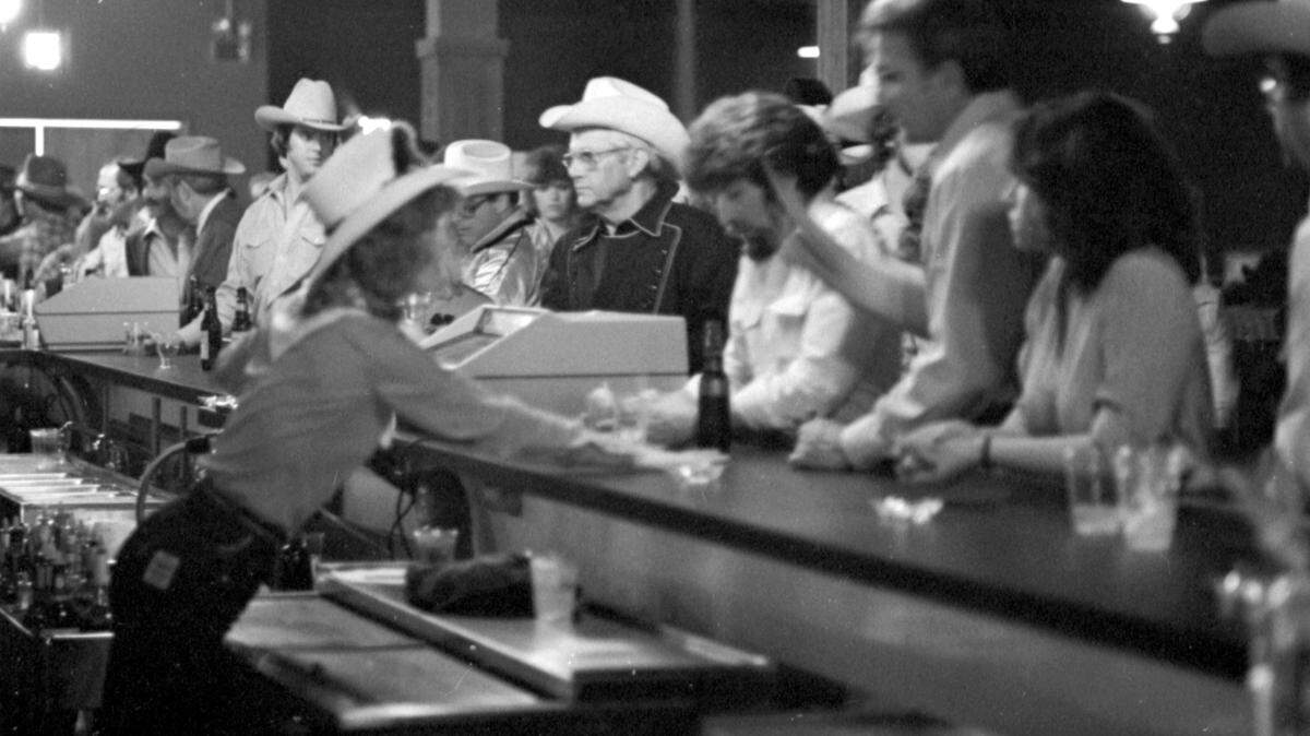 April 2, 1981: Bartenders were busy behind one of four main bars at Billy Bob’s Texas honky-tonk in Fort Worth.
