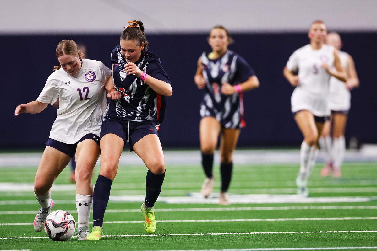 Grapevine forward Eleanor Batik (12) attempts to maintain the ball while pushing off a Frisco Wakeland defender in a Class 5A Division II UIL girls soccer state semifinal at the Ford Center on April 3, 2026 in Frisco, Texas.
