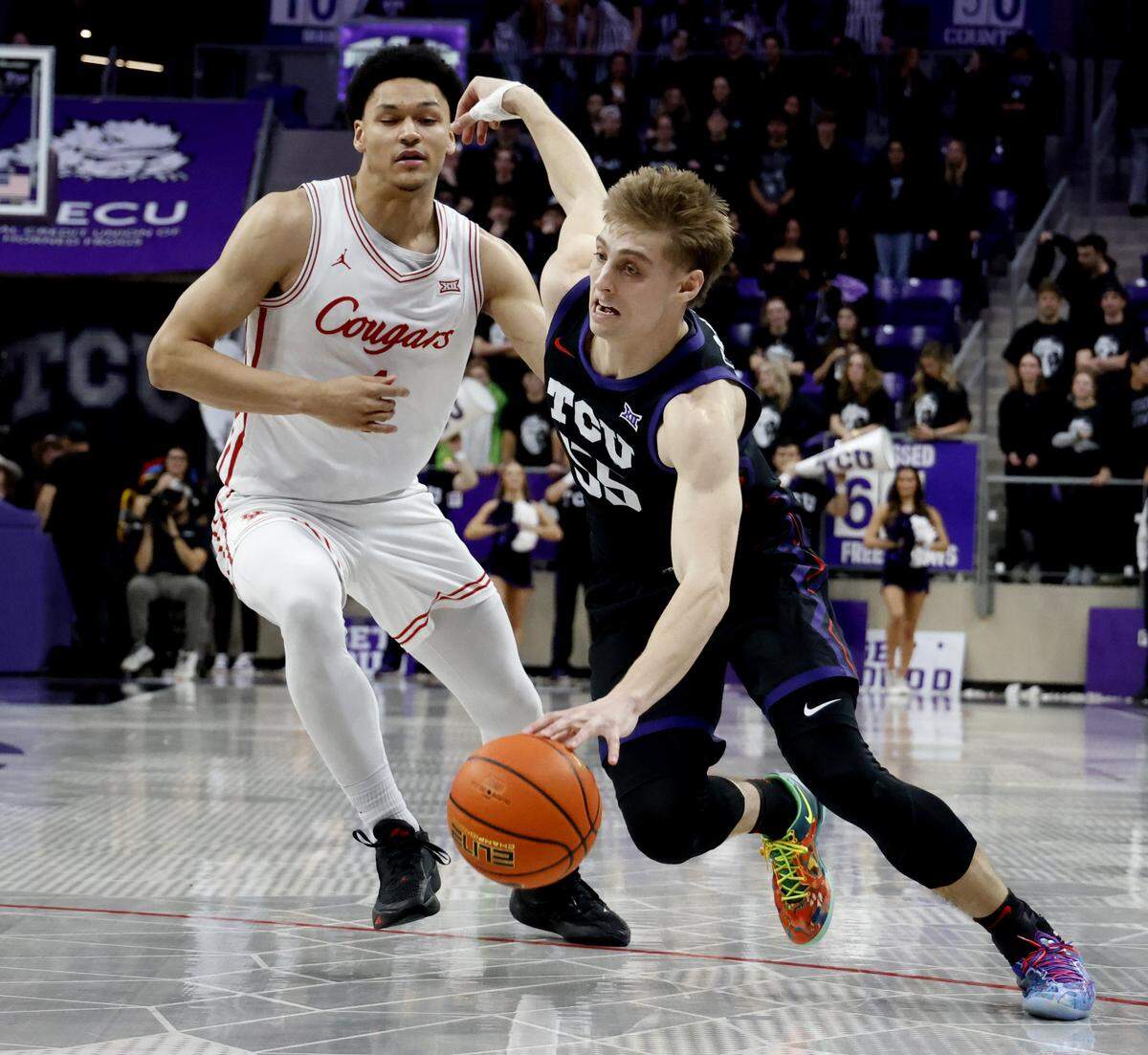 TCU guard Tanner Toolson (55) turns the corner on Houston guard Isiah Harwell (1) during the second half of a NCAA basketball game between the University of Houston and TCU at Schollmaier Arena in Fort Worth, Texas, Wednesday Jan. 26, 2026