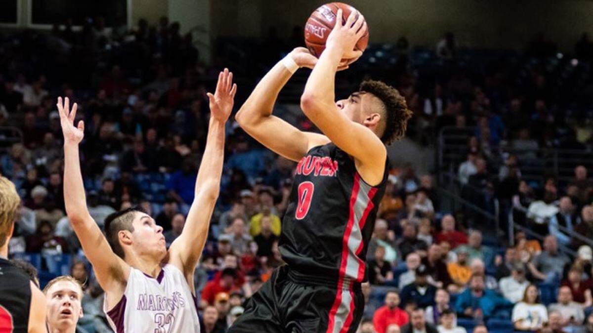 Gruver junior Jaylin Conyers (right) shoots over Martin’s Mill’s Karson Godwin in the 2A state semifinals at the Alamodome, Friday March 8, 2019. Conyers finished with 33 points and 13 rebounds.