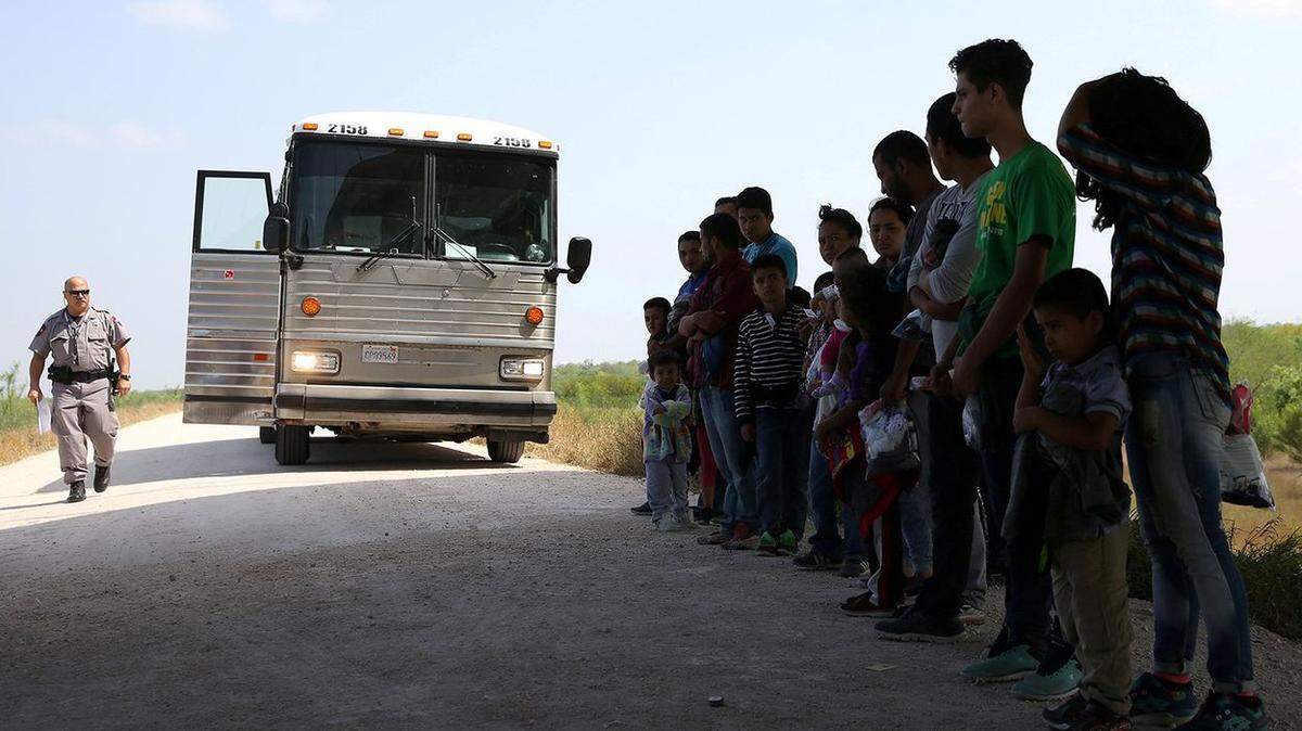 Immigrants who turned themselves in wait to be processed April 2 near McAllen.