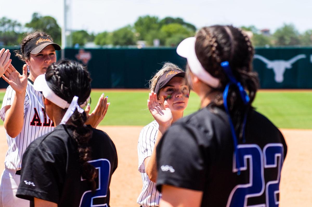 Maddy Jarvis high fives players from Georgetown after the Bearcats’ 2-3 loss in the 5A State Softball semifinal between Aledo and Georgetown in Austin Texas, on June 3rd, 2021.
