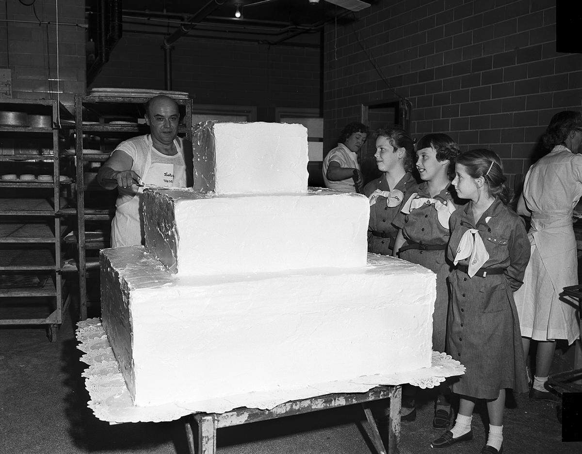 Nov. 8, 1952: Vance Suchocki, Leonard’s baker, finishes a 300-pound cake for the Girl Scout round-up at 7 p.m. Friday in the poultry and livestock exhibit building at Will Rogers Memorial Coliseum. Watching are Girl Scouts Karen Heitt, Jane Lemon and Evalie Hawes.