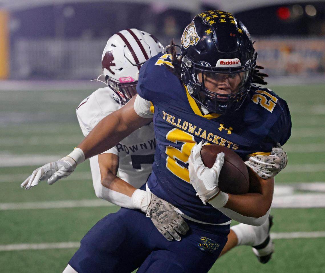 Stephenville running back Zyler McClendon (21) runs down the Brownwood sidelines for yards during a UIL District 4-4A D1 football game at Tarleton State Memorial Stadium in Stephenville, Texas, Friday, Nov. 01, 2024.
