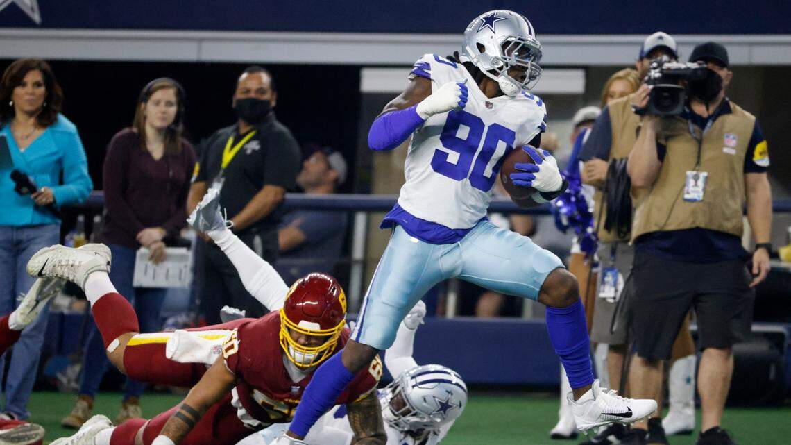 Dallas Cowboys defensive end DeMarcus Lawrence intercepted a pass and returned if 40 yards for a touchdown in the first half against Washington Sunday night at AT&T Stadium.