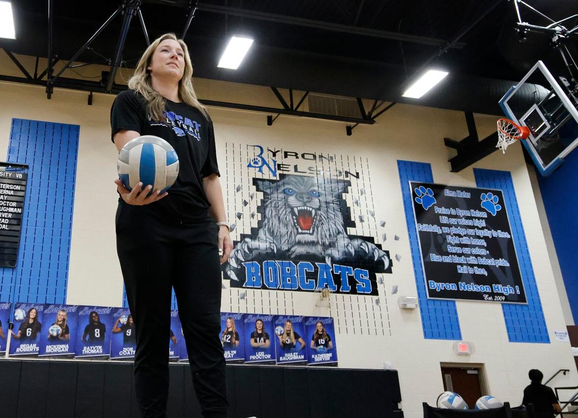 Head coach Brianne Barker Groth serves off a platform during volleyball practice at Byron Nelson High School in Trophy Club Texas, Wednesday, Sept. 25, 2024.