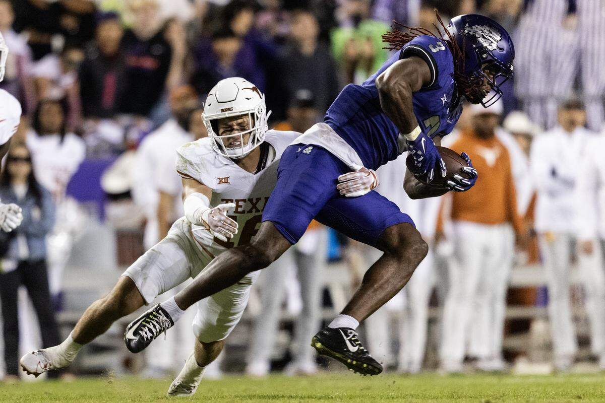 TCU wide receiver Savion Williams gets tackled by Texas defensive back Michael Taaffe uring a game in 2023 at Amon Carter Stadium in Fort Worth. Texas has since moved on to the SEC, while TCU fights for relevancy in the Big 12.