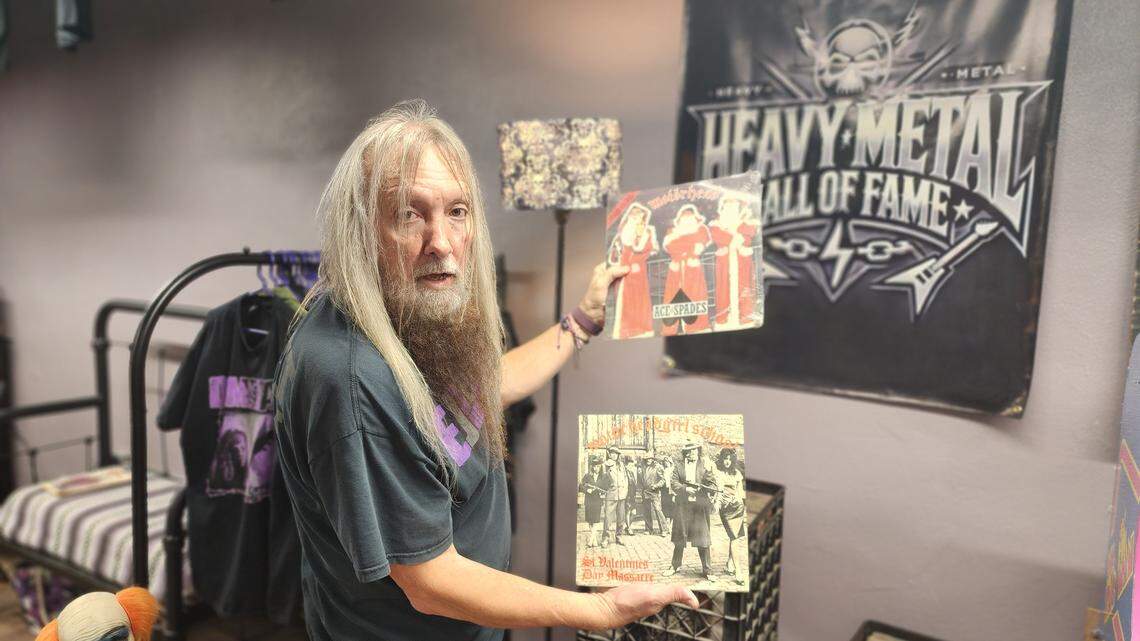 Jerry Warden shows of a couple of the many albums in his record collection at his Heavy Metal Hall of Fame in downtown Arlington.