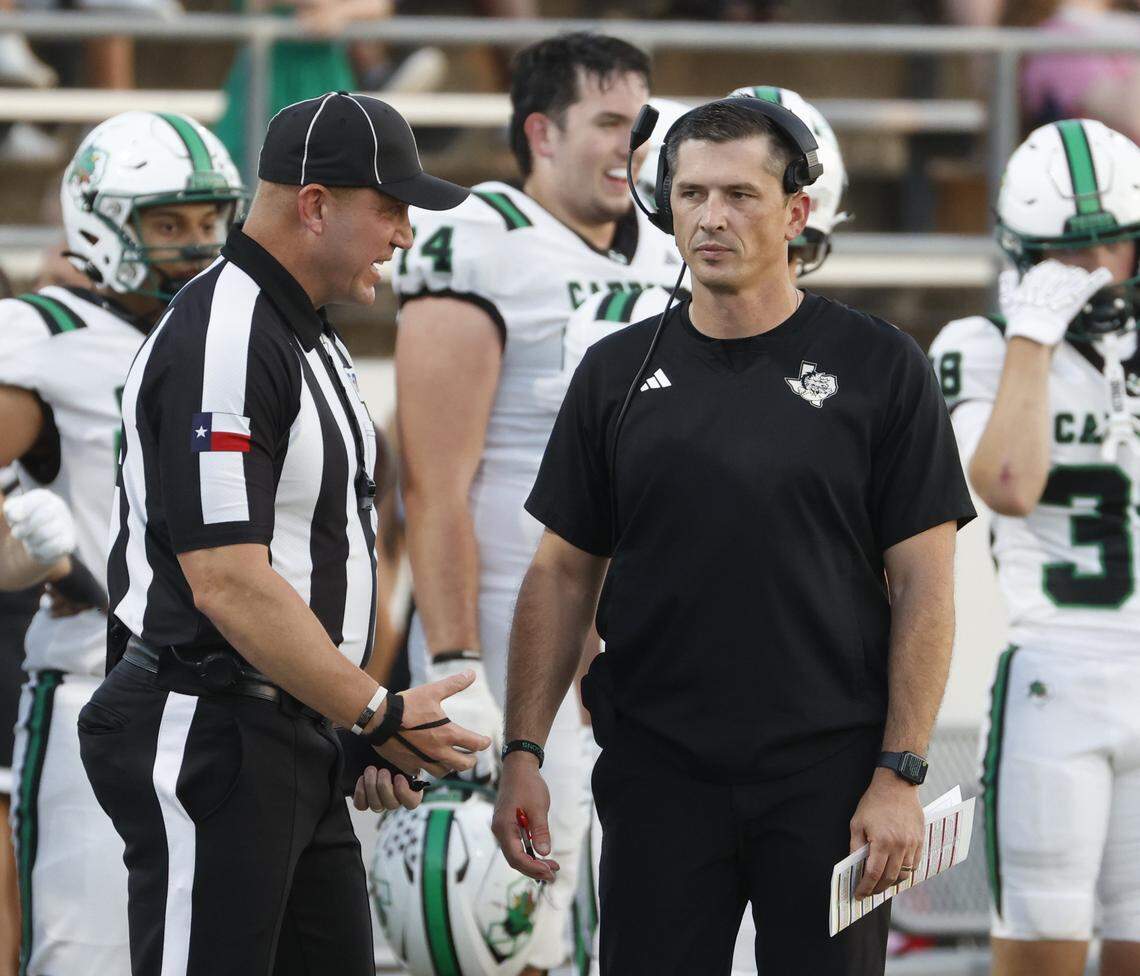 Southlake head coach Riley Dodge talks with line judge Scott Huffman during the first half of a UIL football game between Southlake Carroll  and Byron Nelson at Northwest ISD Stadium in Justin, Texas, Friday, Sept. 12, 2025.