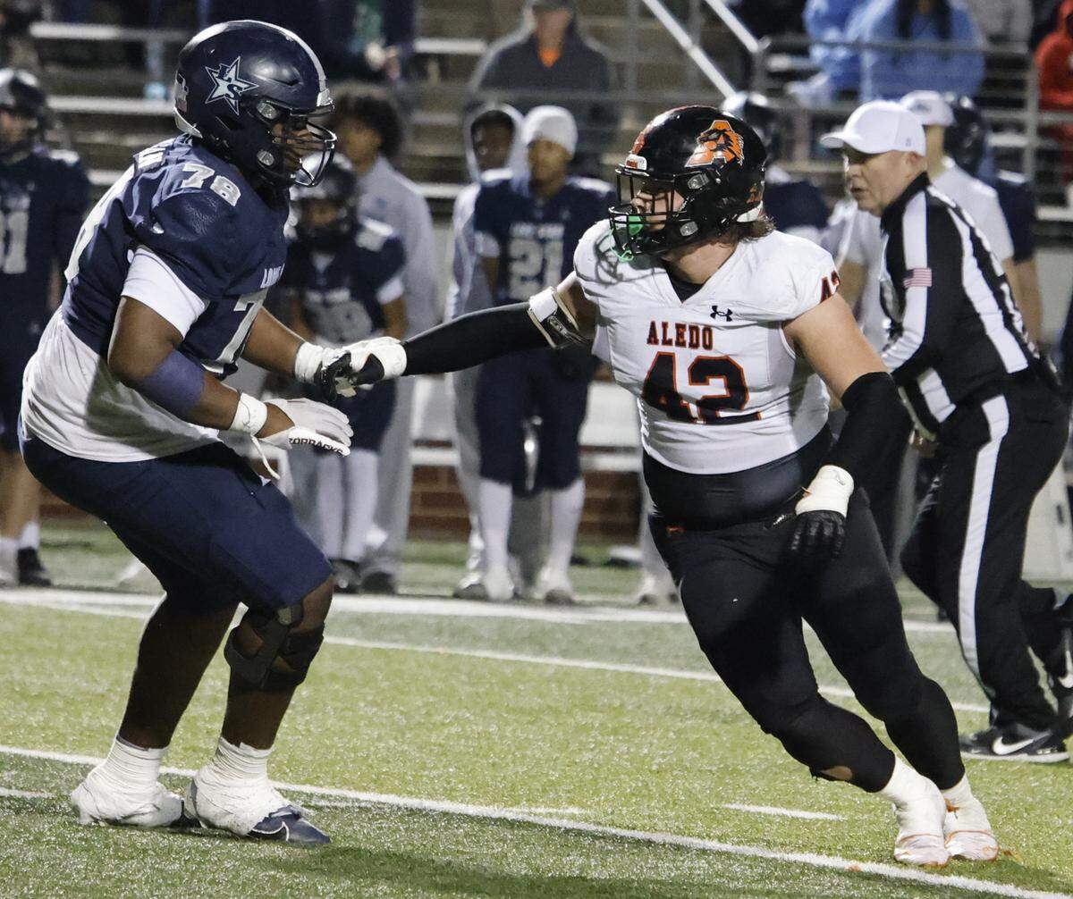 Aledo defensive end Cooper Cyphers (42) works against Frisco Lone Star offensive lineman Kendrick Morgan during the second half of a Class 5A Division I state semifinal Friday at Newsom Stadium in Mansfield.