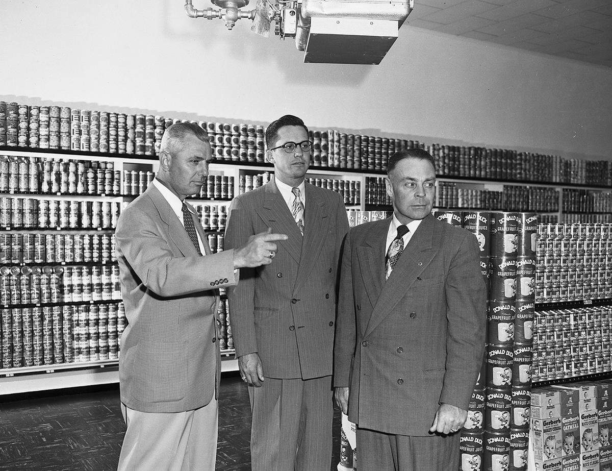 April 28, 1952: Checking over the new Worth Food Market at 5162 Wichita at Mansfield Highway are three Worth officials. They are, left to right, Clyde Stricklin, sales and advertising manager; E.W. Curry, store supervisor, and Russell Boomer, general superintendent and personnel director. (The site today is a CVS pharmacy.)