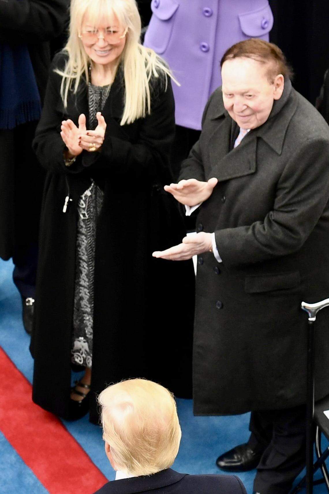 President-elect Donald Trump arrives as billionaire Sheldon Adelson and his wife Miriam Adelson watch during the 2017 Presidential Inauguration at the U.S. Capitol.