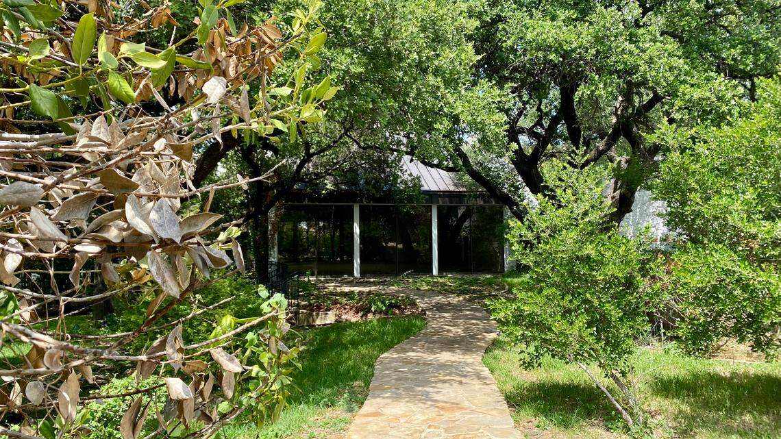 In this file photo from July 2021, dead foliage from the winter freeze lines the entryway to the Stonegate Mansion swimming pool wing, the only section visible from Stonegate Boulevard. Demolition on the 50-year-old mansion began Wednesday.