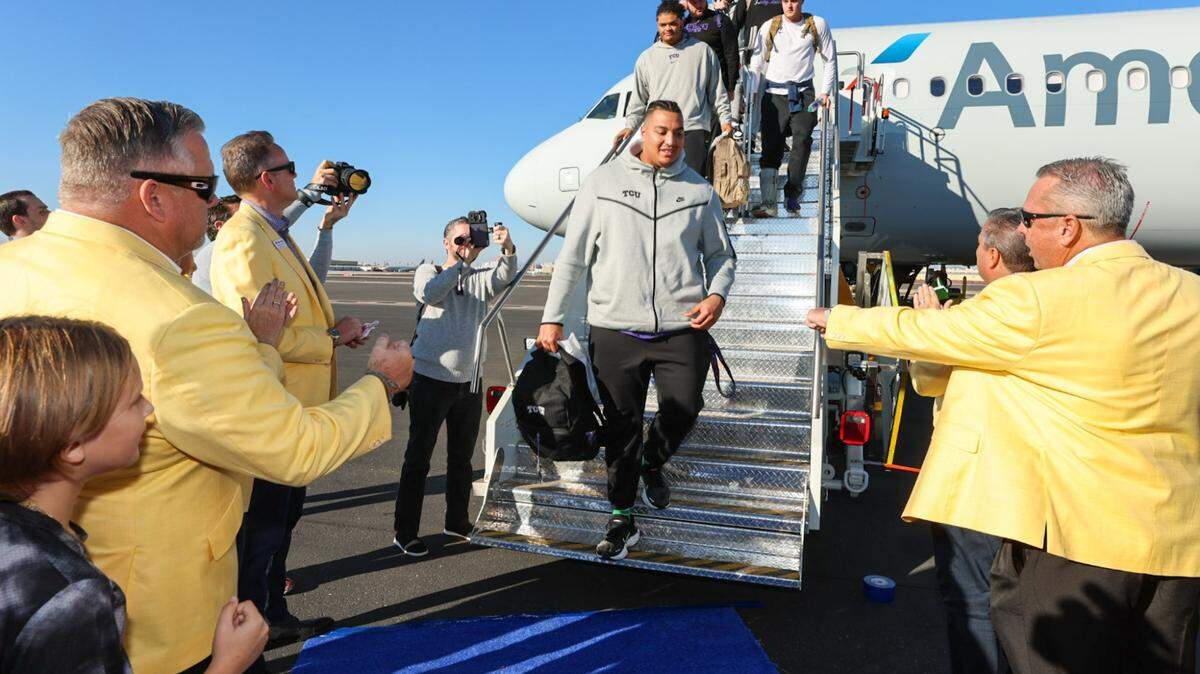 TCU players and coaching staff arrive in Phoenix for the Fiesta Bowl.